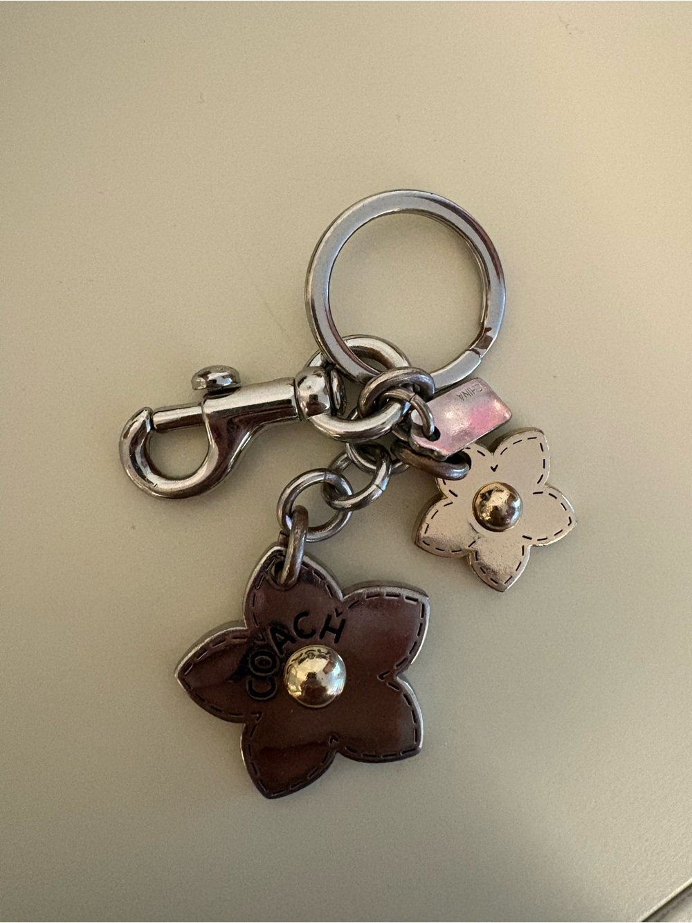 COACH Silver & Bronze Flower Charm Key Ring with Silver Hardware